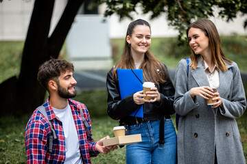 Students Laughing with Books and Coffee on College Campus