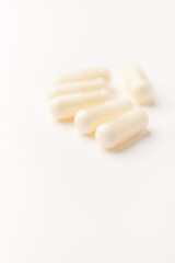 Creatine tablets on paper background. Soft focus. Close up. Copy space.	