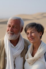 Obraz premium Elderly caucasian couple smiling in desert landscape