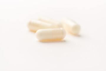 Creatine tablets on paper background. Soft focus. Close up. Copy space.	