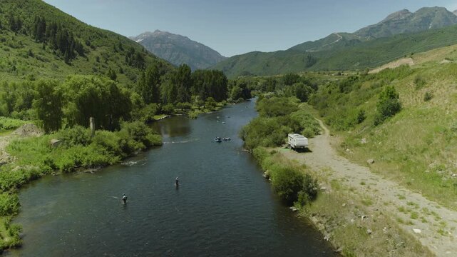 Beautiful Utah river with people fishing and some riding rafts - drone shot