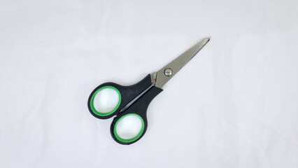 Green scissors on white background. Scissors for cutting paper.
