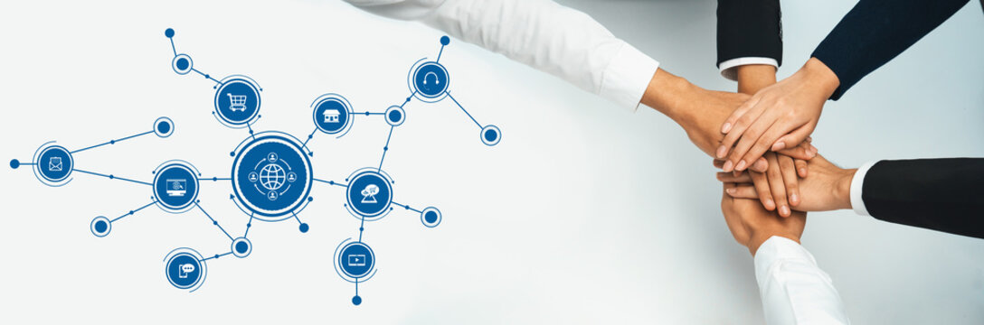 A diverse group of hands come together symbolizing collaboration and teamwork over an abstract digital network, representing global connections in modern business ventures. Amity - Powered by Adobe