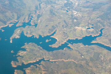 Aerial view of California water reservoir with rugged shoreline and blue water, February 6, 2023