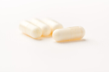 Creatine tablets on paper background. Soft focus. Close up. Copy space.	