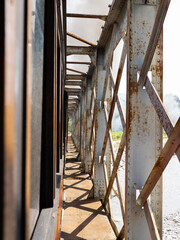 View from a steam train crossing an old iron bridge