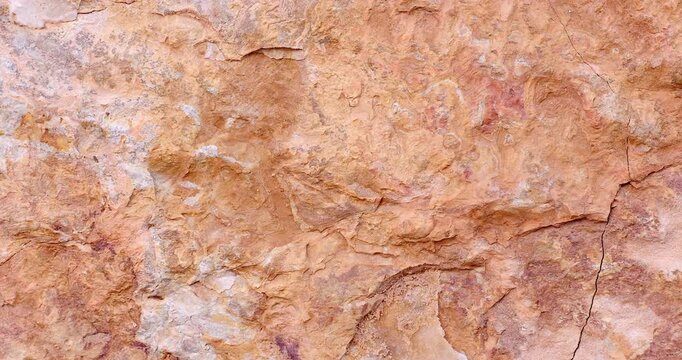 Macro slider motion on sunset color jagged testure rock with cracks and layers