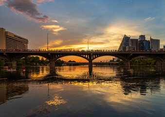 Bat watchers crowd on Congress Avenue bridge waiting for bats to emerge with city skyline in background