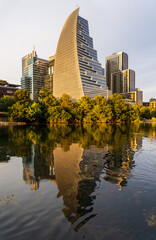 Naklejka premium View of the city skyline of Austin Texas in summer 2025 from Lady Bird Johnson Lake with Sail building