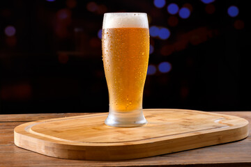 Glass of Cold Beer on a Wooden Board