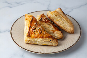 The three-cornered puff pastry with cheese is delicious. Milfoy borek.