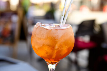 Close-up of Aperol spritz cocktail garnished with orange slice