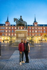 Plaza Mayor Couple: A couple stands embraced, capturing a moment against the backdrop of the iconic Plaza Mayor, the historic landmark.