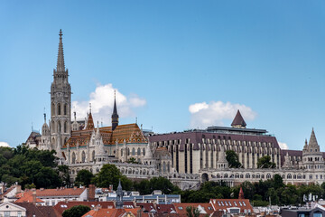 Image of a tall church steeple and majestic buildings in Budapest.