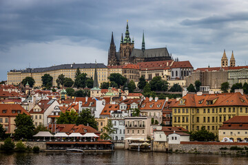 Panoramic image of Prague from the Charles Bridge showing the cathedral as well as various colorful buildings.