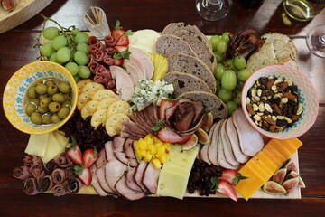 Charcuterie board with assorted meats, cheeses, and fruits