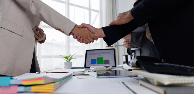 Business handshake for teamwork of business merger and acquisition,successful negotiate,hand shake,two businessman shake hand with partner to celebration partnership and business deal concept
