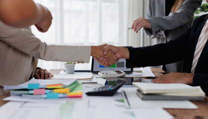 Happy financial advisor Banker and client shaking hands after business loan grant.