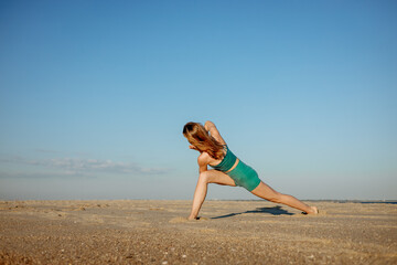Fit woman practicing warrior and twisted lunge yoga poses on a sunny beach. Outdoor yoga session for strength, flexibility, and mindful movement in nature