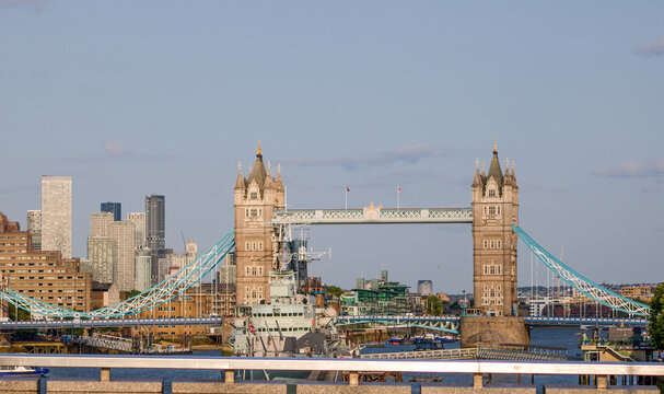 Tower Bridge with HMS Belfast in the foreground and modern skyscrapers in the background, representing the blend of history and modernity in London - Powered by Adobe