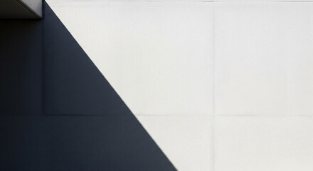 Abstract architectural detail featuring a stark contrast between a dark shadowed area and a bright white wall surface.