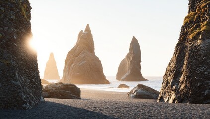 Dramatic basalt columns on a black sand beach, bathed in golden sunlight
