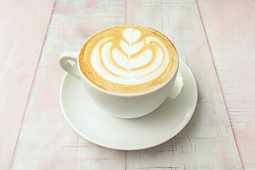 Coffee cup with creamy foam decorated with an design, created by a skilled professional barista