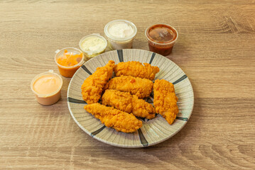Chicken breast strips coated with breadcrumbs and mustard powder, deep-fried in peanut oil.