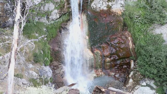 Lower section of Mill Creek Falls cascading through a rocky canyon in Lassen Volcanic National Park, California, surrounded by forested mountain scenery.