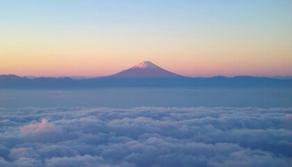 A high-altitude view of a majestic mountain range, covered in clouds.