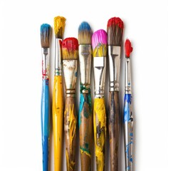 Close-up of several used paintbrushes, various colors, on white background