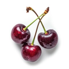 Three ripe cherries, wet with droplets, stems intact, top view against white background