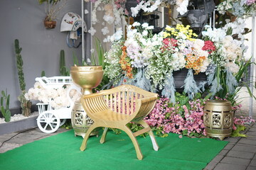 Elegant Decorative Setup with Golden Chair and Floral Accents
