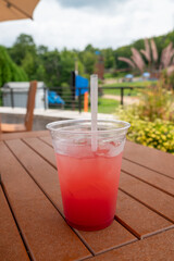cocktail, drink, tropical drink, red drink, beverage, summer, poolside, wooden deck, refreshment, vacation, resort, leisure, relaxation, outdoor, tropical, summer drink, cold drink, fruity drink, alco