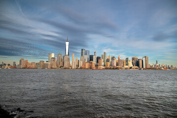 Fototapeta premium City Skyline with Modern Skyscrapers Across Waterfront Harbor