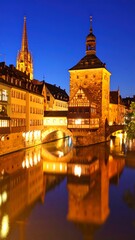 Obraz premium European city at night, historical buildings reflected in calm water