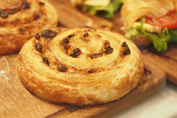 Freshly baked swirl pastry on a wooden board