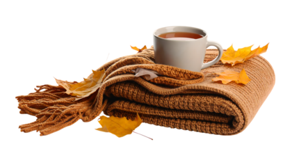 Cozy autumn scene with blanket, cup of tea, and colorful leaves