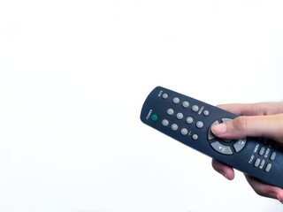 Hand holding a black TV remote control with isolated white background. Ideal for technology, entertainment, lifestyle, smart home, electronics, and user interface concept marketing