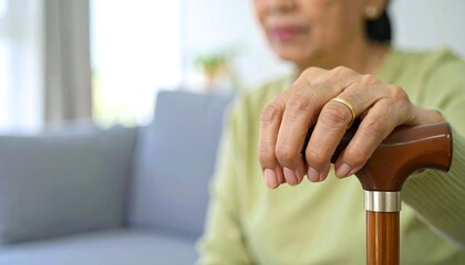 Elderly Woman's Hand on Walking Cane: A Close-Up Portrait of Aging and Resilience