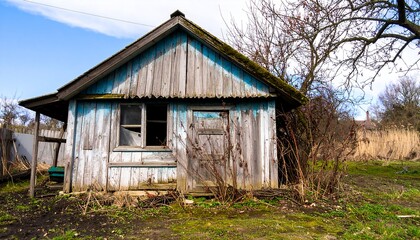 Aged wooden shed in a rural landscape.