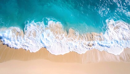 Aerial view of turquoise ocean waves breaking on a sandy beach