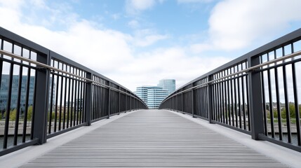 Modern pedestrian bridge with a view of urban skyscrapers on a cloudy day.