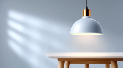 Obraz premium Modern pendant lamp illuminating a wooden table in a minimalist setting.
