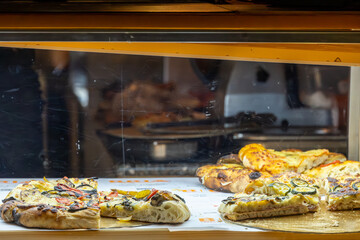 Cagliari, Sardinia, Italy  Focaccia and pizza on display and  for sale in a restaurant.