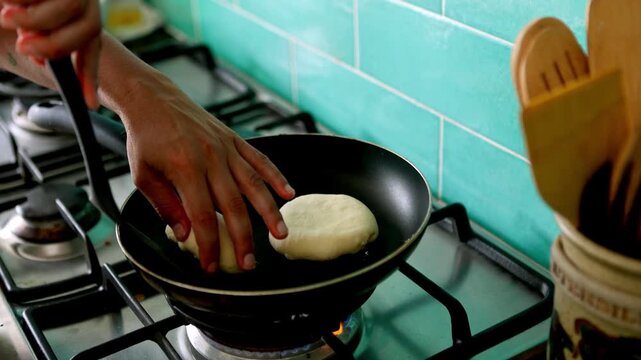 Chef cooking arepas on a pan
