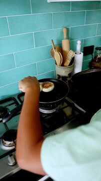 Chef flipping arepas on a pan