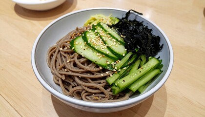 korean cold soba noodle bibim guksu with cucumber, nori flakes, and sesame seed 