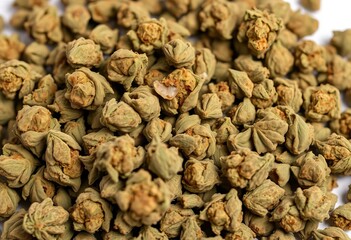A haphazard pile of dried cannabis buds, varying in size and shade of green,  sativa,  substance