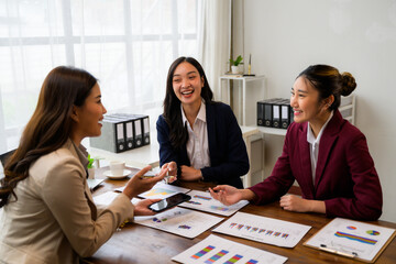 Businesswomen discussing marketing strategy during meeting in office